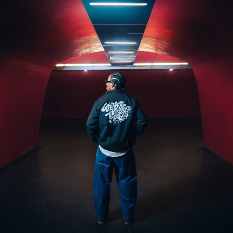 Coach Jacket — UFA 2026, worn from behind, tunnel