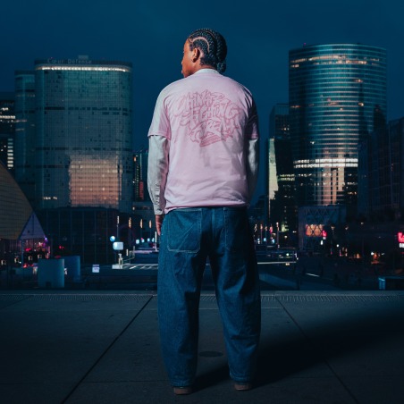 Pink Edition Tee — UFA 2026, worn from behind, skyline