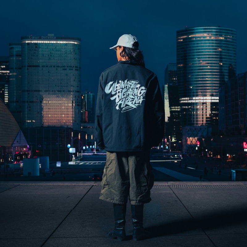 Coach Jacket — UFA 2026, worn from behind, skyline